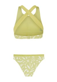 Bikini set u limetasto zelenoj boji sa sportskim topom s preklopom i odgovarajućim gaćicama s bijelim uzorkom lista. Glatka tekstura, rastezljiv materijal.