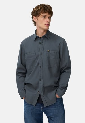 Gray button-up shirt with long sleeves, two chest pockets, and a collar, made of a smooth fabric. Worn with blue jeans.