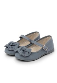 Gray canvas flats with a knot detail on the toe, strap across the instep, and a flat rubber sole. Smooth texture with a simple design.