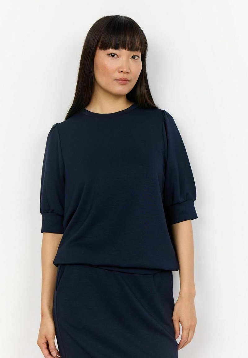 Top blu navy a maniche corte con scollatura rotonda e maniche a palloncino. Tessuto morbido con una texture liscia; design con vestibilità rilassata.