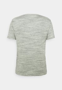 Vue arrière d'un t-shirt gris clair chiné à manches courtes avec une texture horizontale subtile sur fond uni.