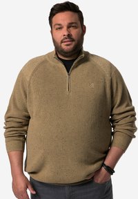 Beige stickad tröja med dragkedja, i texturerat tyg, med ribbade ärmslut och spräckliga detaljer genom hela plagget.