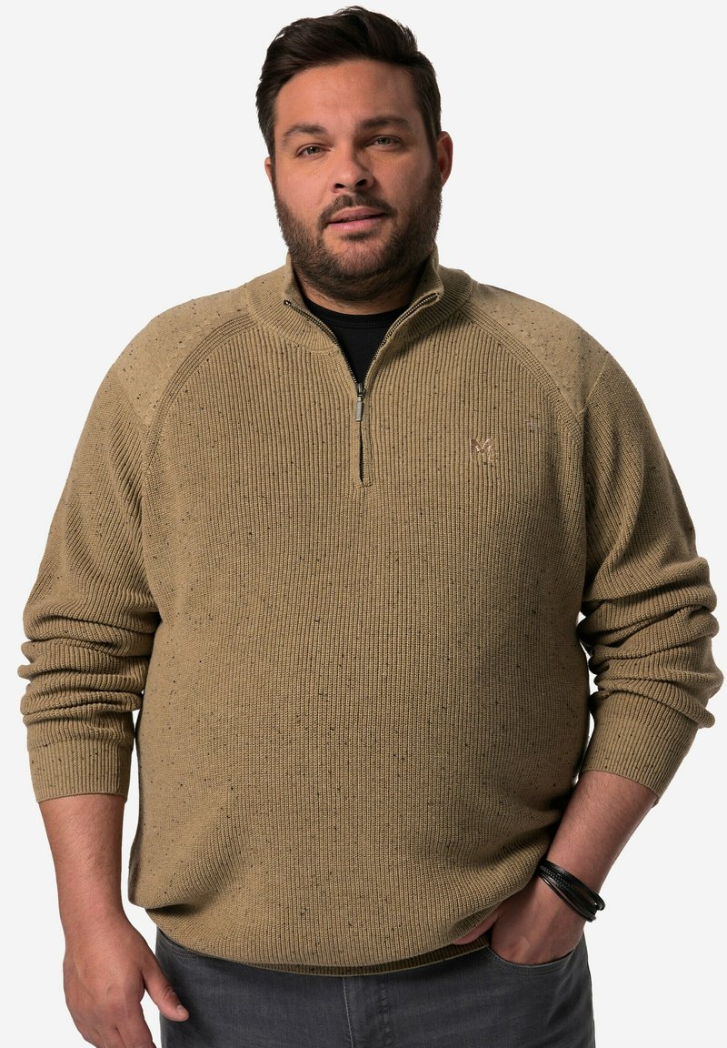 Beige stickad tröja med dragkedja, i texturerat tyg, med ribbade ärmslut och spräckliga detaljer genom hela plagget.