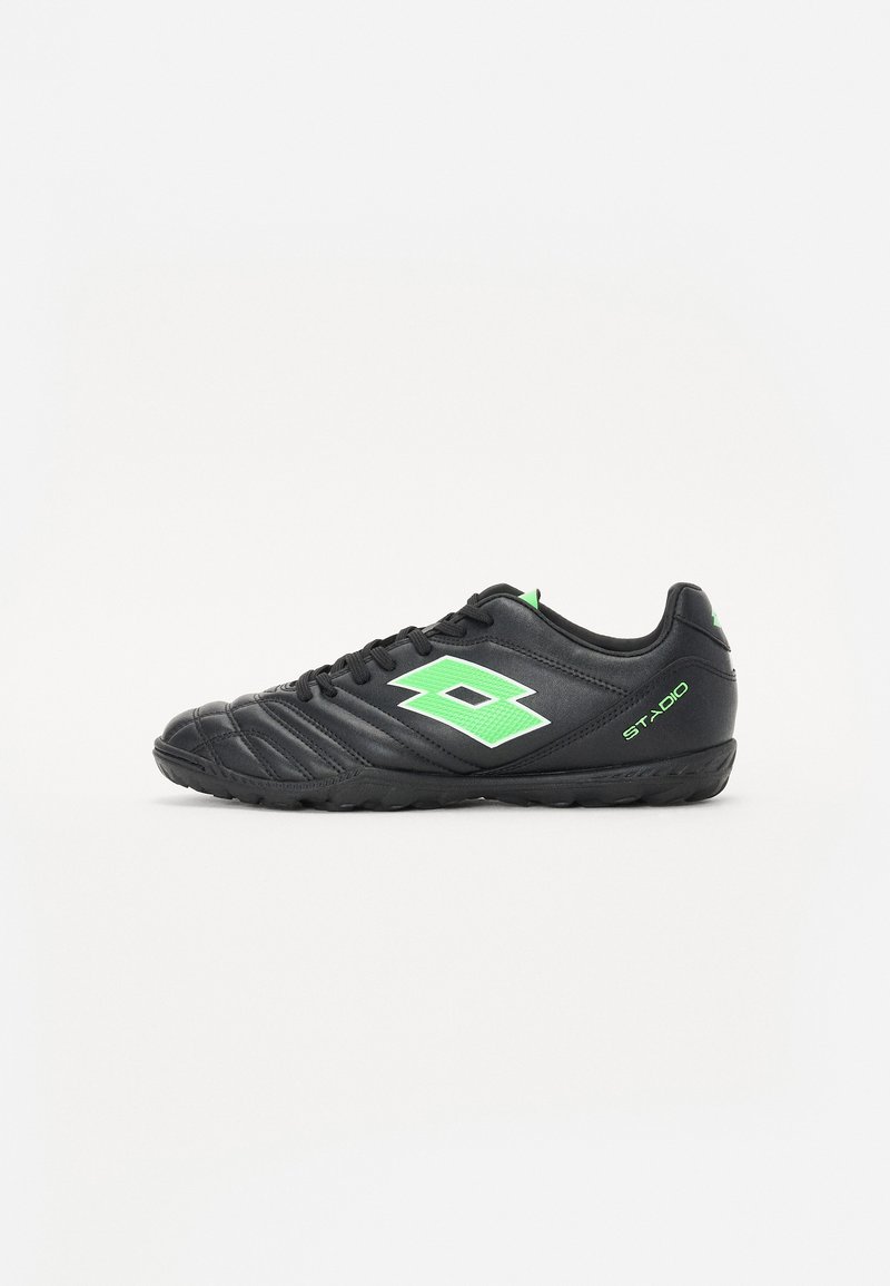 Black synthetic soccer shoes with textured surface, green logo, and accents. Features rounded toe, lace-up front, and rubber outsole.