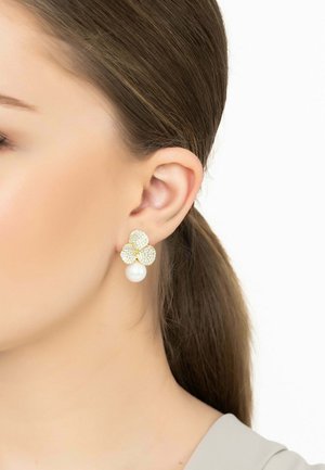 Gold-tone flower earrings feature a petal design with rhinestones and a bottom pearl accent. Glossy texture with sparkling details.