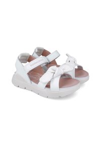 Sandalias blancas con una parte superior sintética suave, correas ajustables y un nudo decorativo en la puntera. Plantilla acolchada y suela de goma.