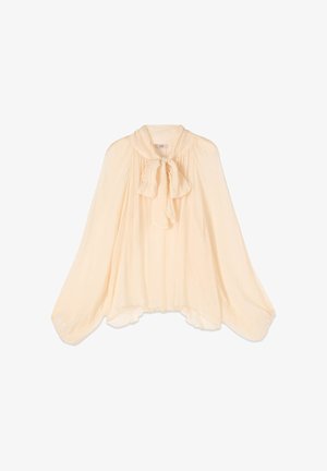 Blusa transparente color crema con mangas largas abullonadas y un lazo atado en el cuello, tela fluida y dobladillo ligeramente desigual.