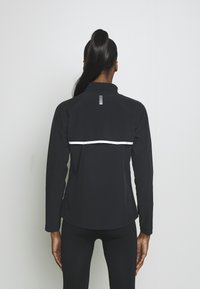 Under Armour Běžecká bunda - black
