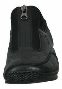 Black slip-on shoe with a leather upper, elastic side panels, and a central zipper. Textured sole with a wavy pattern for grip.