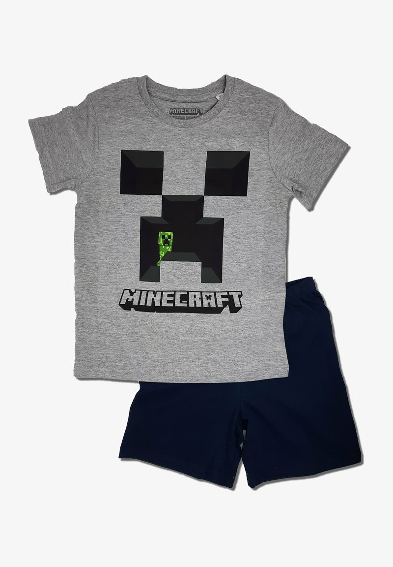 Graues T-Shirt aus Baumwolle mit einem schwarz-pixelierten Creeper-Grafik und dem Text "MINECRAFT"; kombiniert mit navyblauen Shorts.