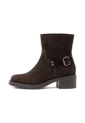 Dark brown suede ankle boot with block heel, rounded toe, and decorative side strap with metal buckle.