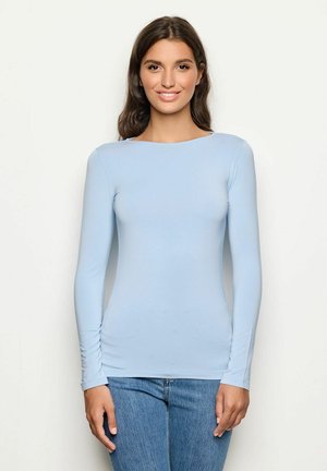 Light blue long-sleeve top in a fitted design, made from a soft material; features a round neckline and smooth texture.