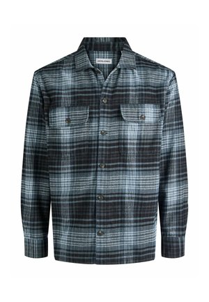 Camisa de cuadros en negro y gris con dos bolsillos en el pecho, cierre de botones y cuello ancho. Confeccionada en tela texturizada con patrones de rayas variados.