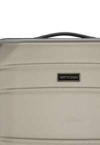 WITTCHEN Hartschalenkoffer in hellem Beige mit strukturierter Oberfläche, schwarzem Griff und Markenlogo aus schwarzem Metall. Glattes, aerodynamisches Design.
