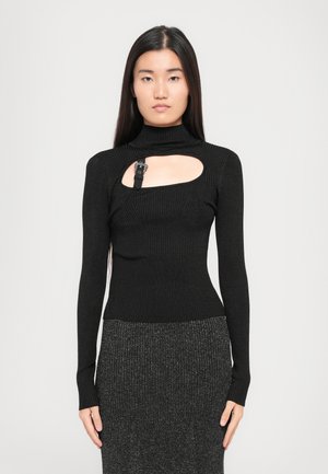 Black ribbed long-sleeve top featuring a mock neck, cutout at the chest, and a strap with a buckle detail on the left side.