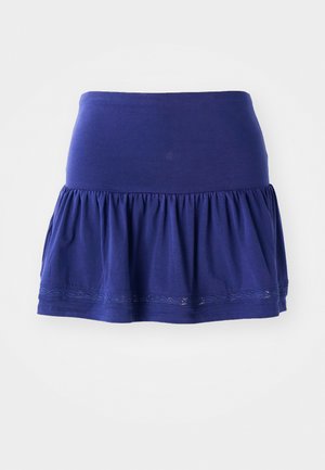 Navyblauwe tricotrok met een geraffineerde onderkant, een elastische tailleband en decoratieve geborduurde rand langs de zoom. Zacht, lichtgewicht materiaal.
