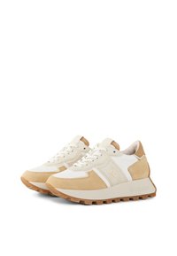 Tan and white athletic shoes with suede and textile materials, featuring a textured sole, lace-up design, and subtle branding on the side.
