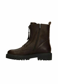 Bruine leren enkelboots met een gestructureerde afwerking, ritssluitingen aan de zijkant en robuuste rubberen zolen. Voorzien van een trekstrip aan de achterkant voor eenvoudig aan- en uittrekken.