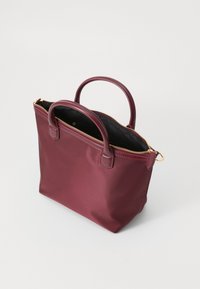 Maroon satin bag with double handles, a zip closure, black interior, and gold hardware accents. Rectangular shape with smooth texture.
