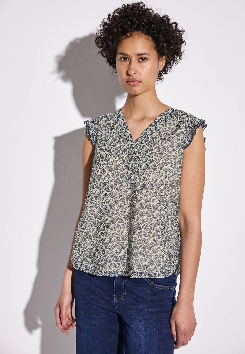 Kevyt, kuvioitu pusero V-pääkohdalla ja hihattomilla hihoilla. Hulahduttaa kukkakuosisia vaaleanpunaisista ja laivastonsinisistä väreistä. Pehmeä rakenne.