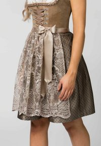 Brown dress featuring lace overlay and satin tie. The bodice has a lace-up design and decorative hardware; skirt with intricate patterns.