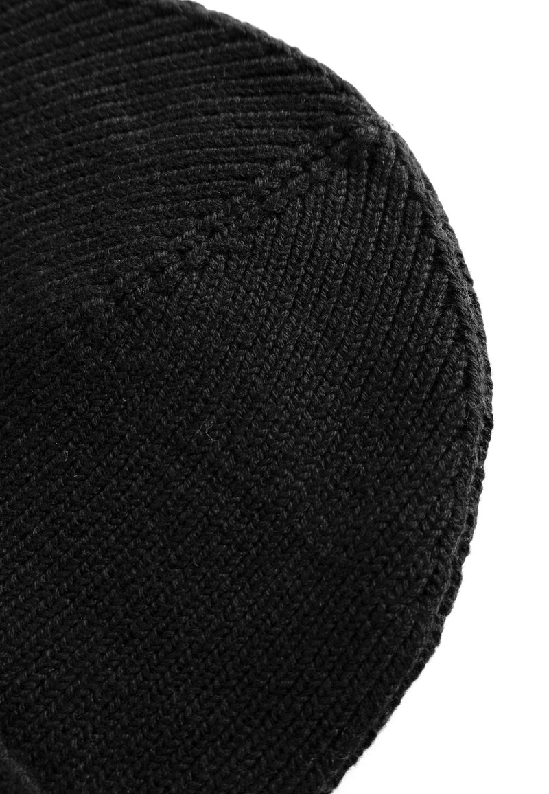Black knitted beanie featuring a ribbed texture and seamless design, with a rounded top and a soft, flexible fit.