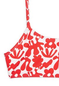 Top bikini rosso e bianco con motivi floreali astratti e onde, realizzato in tessuto morbido e con spalline regolabili.