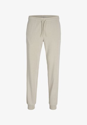 Pantaloni sportivi beige a gamba affusolata con vita elastica, coulisse, tasche laterali e polsini a costine alle caviglie, progettati per un look casual.