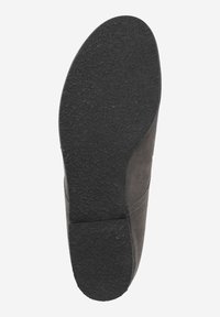 Semelle de chaussure en caoutchouc noir avec une surface texturée, présentant une légère courbure au niveau du talon et une zone lisse près des orteils.