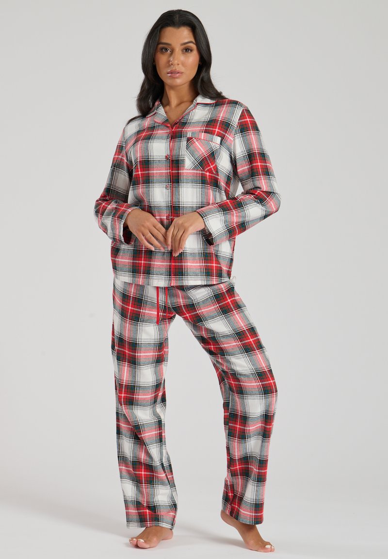 Red, black, and white plaid pajama set with long sleeves, a button front, and a chest pocket. Pants feature an elastic waistband.