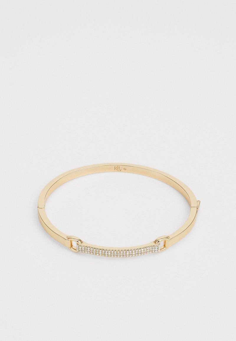 Bracciale rigido dorato con barra rettangolare decorata con piccoli cristalli trasparenti.