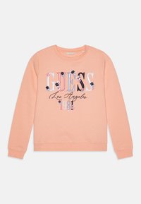 Perzikkleurig sweatshirt gemaakt van zachte stof, met geborduurd "GUESS" logo, bloemaccenten en een ronde halsontwerp.