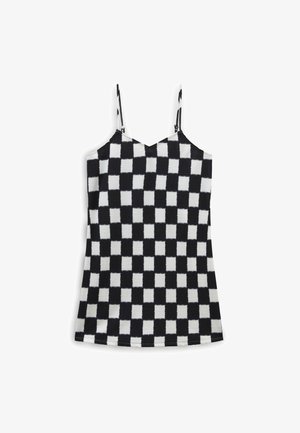 Black and white checkered camisole with thin straps, featuring a textured, ribbed fabric and a V-shaped neckline.