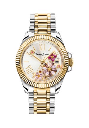 Two-tone gold and silver wristwatch with Roman numerals, date display, and floral gemstone decorations on the face.