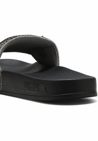 Grå slidesandal med en tekstureret stofrem og sort gummisål. Har en forhøjet hæl og præget PUMA-logo på siden.