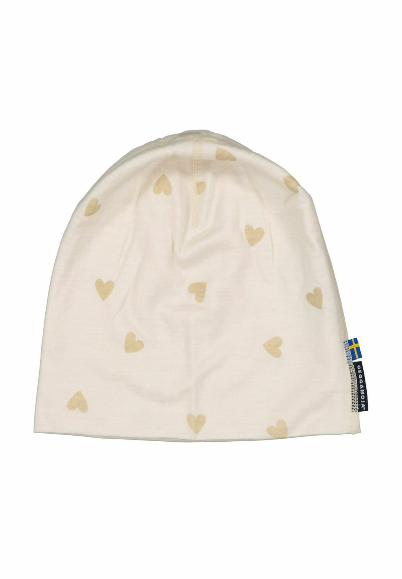 Kermamodulli, jossa on pieniä beige sydänkuvioita, pehmeää kangasta, pyöreä muoto ja sivulappu, jossa on sinisen ja keltaisen lipun kuvio.