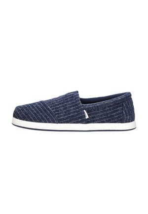 Donkerblauwe instapschoen met witte zool, gestructureerde stof en subtiele verticale strepen, zijlabeldetail, casual stijl.