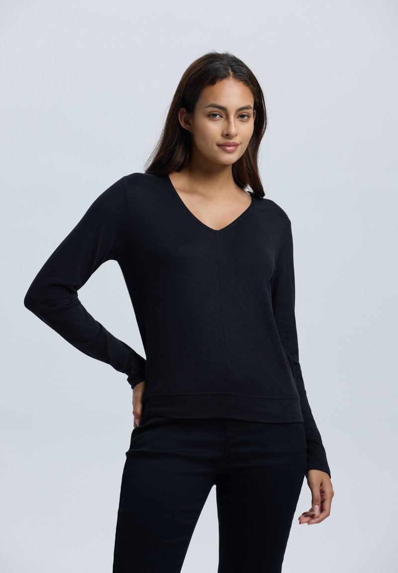 Zwart langermig V-hals sweatshirt van zachte stof, met een getailleerde silhouet en een elastische onderrand, met minimale stikdetails.