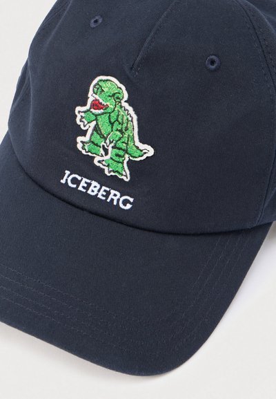 Casquette en coton bleu marine ornée d'un motif brodé de dinosaure vert sur le devant, avec le texte « ICEBERG » en blanc sous le design.