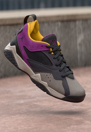 Basketball shoes in gray, black, and purple, featuring mesh and suede material, flat laces, rubber sole, and a yellow interior.