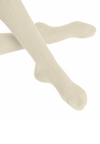 Chaussettes montantes de couleur crème clair, avec une texture côtelée et de petits pois rouges sur les côtés, dotées d'un design confortable pour les orteils et le talon.