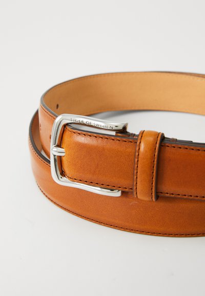 Brown leather belt with a silver metal buckle, featuring stitched edges and a smooth texture. The buckle is engraved with "Tiger of Sweden."