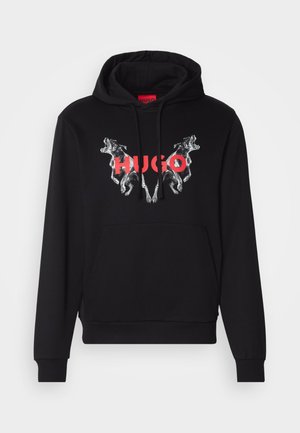 Black hoodie featuring a large graphic of two dogs and the brand name "HUGO" in red. Includes a front pocket and drawstring hood.