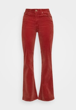 Spodnie sztruksowe w kolorze rdzy z wysokim stanem, zapinane na guzik i zamek, z przednimi kieszeniami i lekko rozszerzanymi nogawkami.