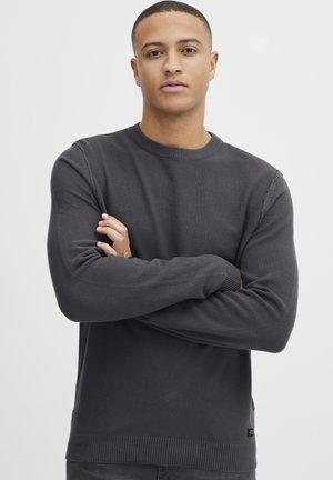 Dark gray knit sweater with a crew neckline, ribbed cuffs and hem, and textured surface. The design is simple with no visible patterns or graphics.