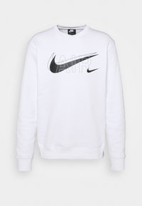 Vit sweatshirt i mjuk bomull, med en stor svart Nike-logotyp och texten "AIR" i mitten. Ribbad mudd och nederkant.