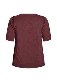 Bordo majica s kratkimi rokavi, okroglo izrezana in z teksturiranim materialom. Ima rahlo nabranim ramena in sproščen kroj.