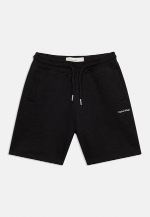 Sorte Calvin Klein-shorts med elastisk midjebånd, snøring, sidelommer og liten hvit logo på venstre lår.