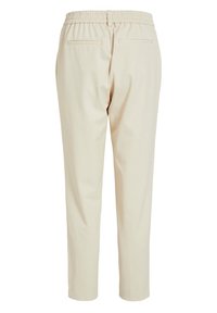 Pantalons beige ajustés avec une taille élastique et deux poches passepoilées à l'arrière, présentés sur un fond blanc.