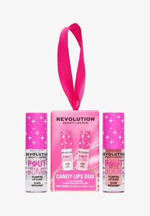 Deux gloss repulpants Revolution Beauty à bouchon rose et une étiquette cadeau rose portant la mention Candy Lips Duo avec un ruban suspendu.
